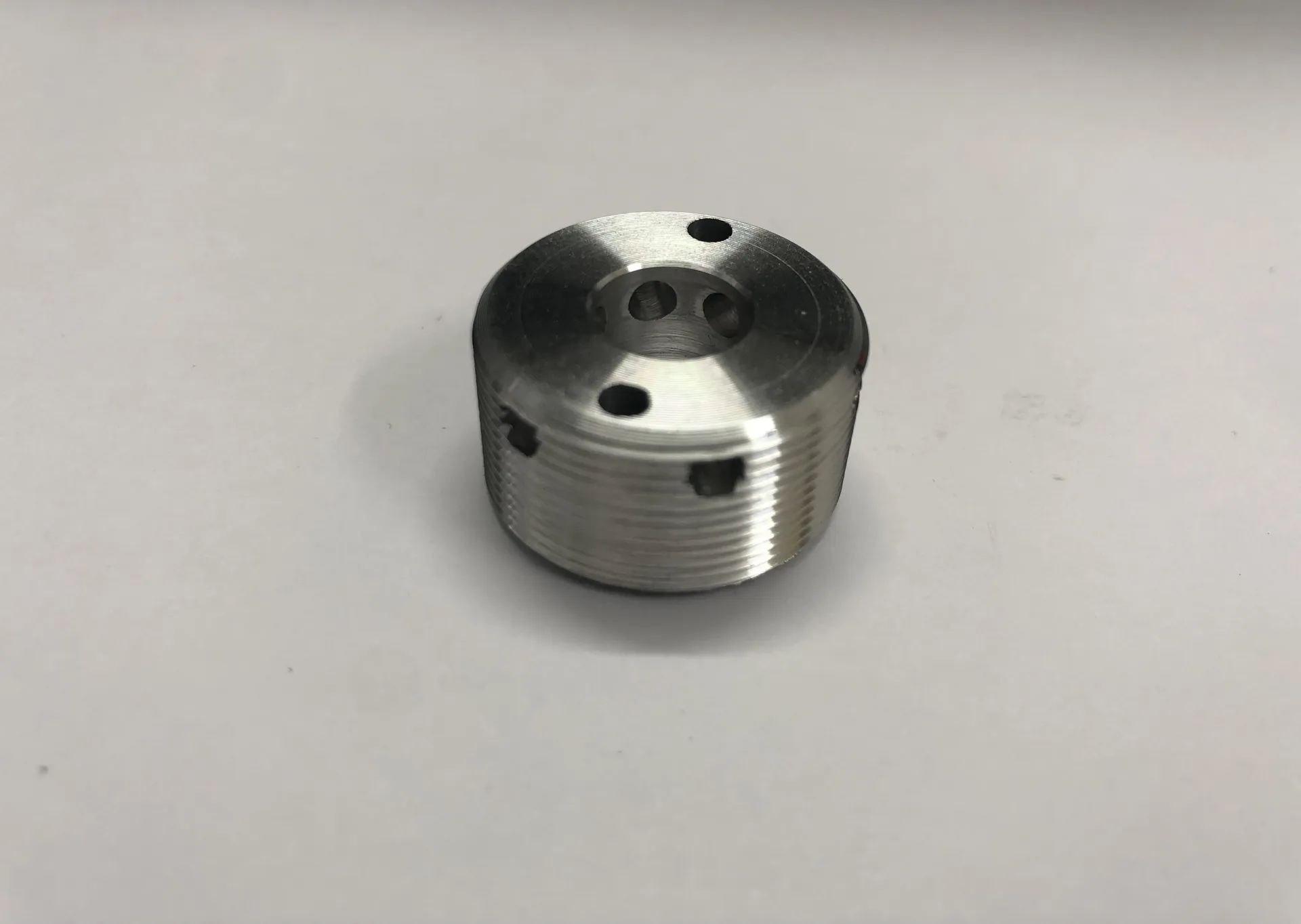 Aluminium nut with radial and axial holes