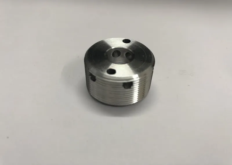 Aluminium nut with radial and axial holes