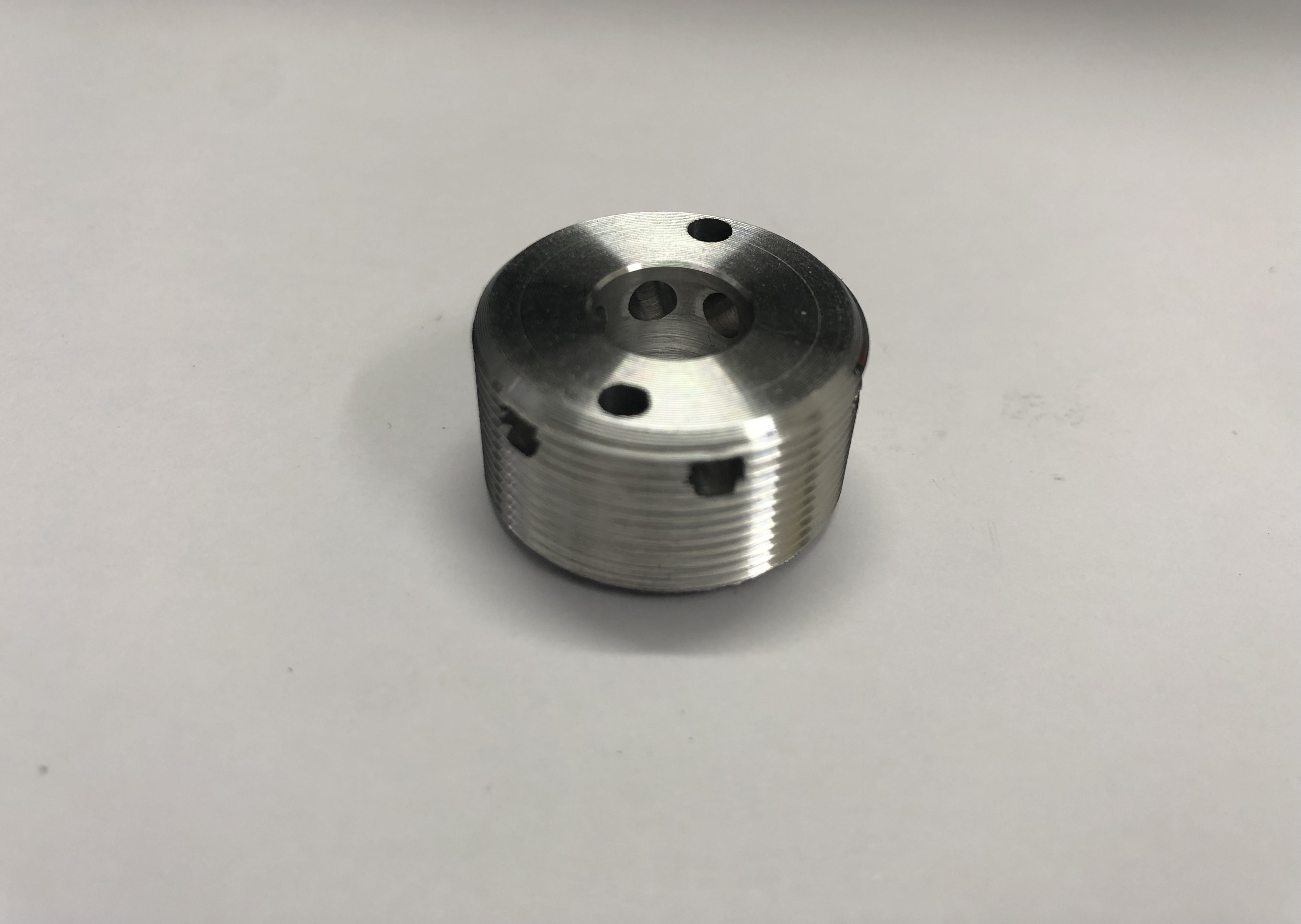 Aluminium nut with radial and axial holes