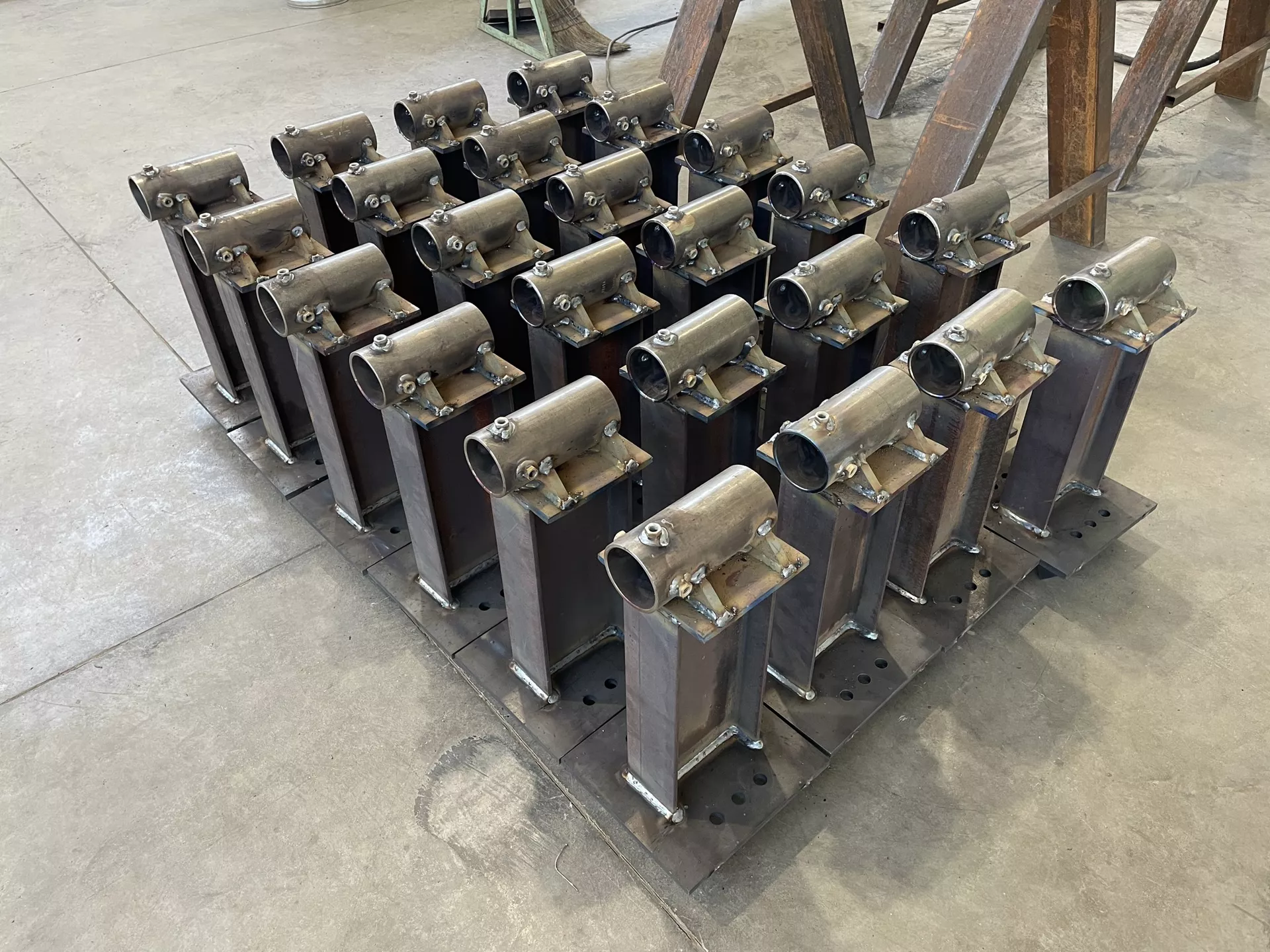 Batch production of welded steel brackets and mounting assemblies.